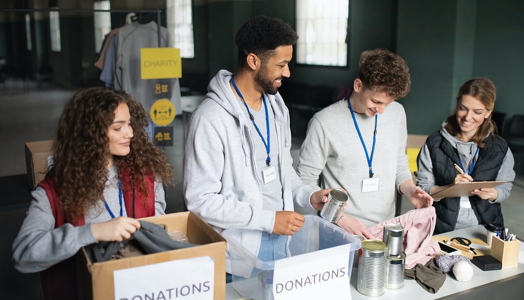 Group of volunteers working in community charity donation center