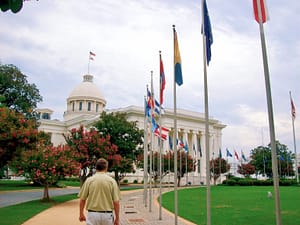 The Alabama State Capitol in Montgomery AL & man walking on premises while traveling USA’s 50 States